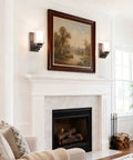 Living room with dark bronze vanity wall light, dual glass shades, transitional fixture above fireplace, modern classic mount
