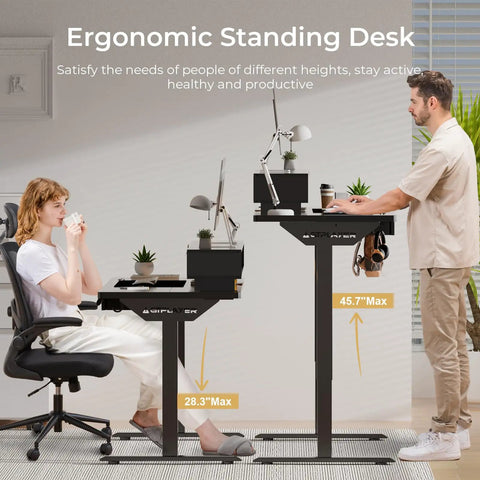 Electric Standing Desk With Drawers 48 By 24 Inch Height Adjustable Gaming Desk With Monitor Stand Power Outlets LED Lights And Memory Preset Perfect For Home Office Or Gaming Setups Black, shown at sitting and standing heights in a room setting with a man and woman.