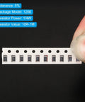 Hand holding strip of 1206 SMT Resistor Kit With 460 Pieces Featuring 46 Values From 10 Ohm To 1 Mega Ohm One Quarter Watt Surface Mount Chip