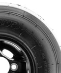 Close-up of 11x7.10-5 go kart tire, 4-ply race slick, mounted on a 5 inch rim, showing sidewall and tread details.