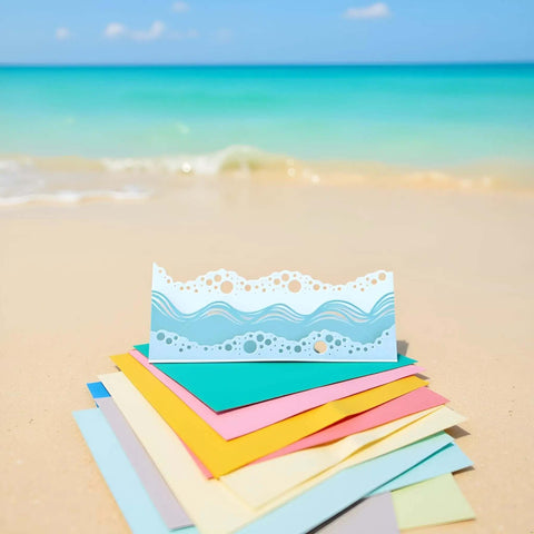 Beach Wave Metal Cutting Dies Set For Scrapbooking And Card Making placed on colorful paper sheets by ocean shore.
