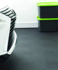 Car parked on Interlocking 18x18 Inch Rubber Floor Tiles For Home Gym Garage Basement And Trade Show Flooring, raised coin pattern