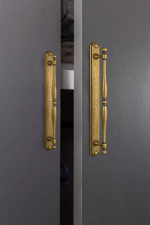 Vintage Spindle Style 2 Pack Antique Brass Cabinet Pulls With Backplates, Distressed Finish on dark cabinet doors