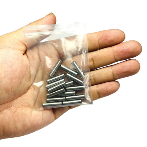 Rock Solid Heavy Duty 3/16x3/4 Inch Dowel Pins and Shelf Pegs in a hand, stainless alloy steel pins for furniture use.