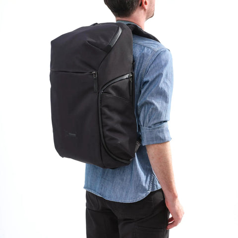 Man carrying Urban Explore 30L Camera Backpack For Travel And Everyday Photography, Carry On Friendly, Anthracite Shell