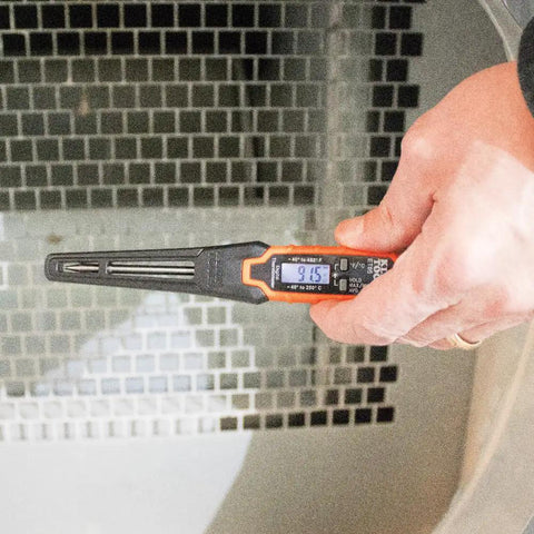 Hand using digital pocket thermometer from HVAC Tool Kit With 3 In 1 Pocket Screwdriver 8 In 1 Screwdriver And Nut Driver And Digital Pocket Thermometer Compact Pocket Friendly 3 Piece Set For Quick HVAC Repairs And Everyday Jobsite Fixes on reflective surface, close-up view.