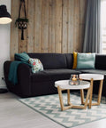 Modern living room with black sofa, wooden accent wall, and floor lamp providing bright light. A19 LED Light Bulb 100W Equivalent Daylight Dimmable 15W Energy Saving Bulb With 10,000 Hour Lifespan 16 Pack White Bright Light For Home And Office Spaces illuminating room.