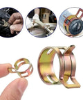 Close-up of 75 Piece Spring Hose Clamp Set For 6 To 10mm Tubing In Galvanized Carbon Steel Heavy Duty Fuel Line Clamps Ideal For Vacuum Hose Gas Pipe Lawn Mower Snowmobile And Motorcycle Maintenance with hands demonstrating use.
