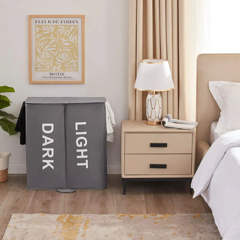 Big Ol Double Laundry Hamper With Lid And Removable Bags next to bedroom nightstand, showing dark and light sections, gray