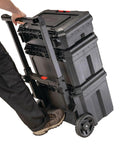 Person transporting TradeStack Rolling Tool Box With Wheels IP65 Waterproof And Stackable Portable Chest, durable plastic storage, 22.5 inch