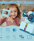 Instant Print Camera For Kids 3 To 12 Blue Inkless Selfie Toy With Printing Paper And 5 Colored Pens Great For DIY Photo Crafts Scrapbooks And Kid Friendly Gift, child holding camera