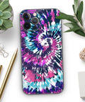 Full Body iPhone 13 Skin Wrap Kit Spiral Tie Dye V3 With Air Release Adhesive in pink, blue swirl pattern on a table