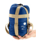 Warm Weather Outdoor Sleeping Bag Waterproof Ultra Lightweight And Compact With Compression Sack held in hand