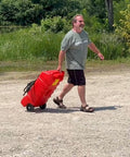 Man pulling Flo N Go 14 Gallon Gas Caddy On Wheels With 53 Liter Portable Fuel Tank And Built In 10 Foot Hose And Fuel Transfer Pump
