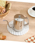 Smooth Pour Long Spout Coffee Kettle With Lid Stainless Steel Tea Pot for brewing beside coffee cup and pastries.