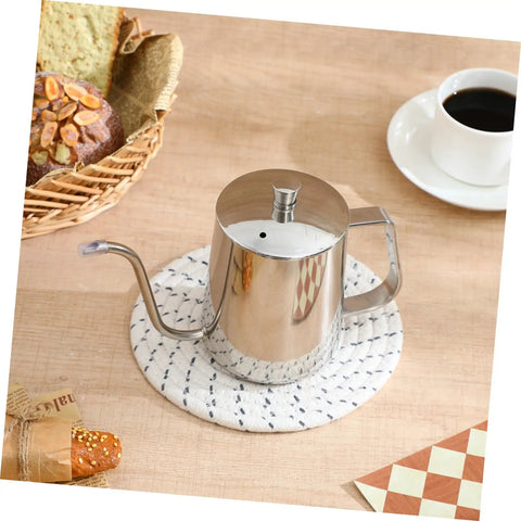 Smooth Pour Long Spout Coffee Kettle With Lid Stainless Steel Tea Pot for brewing beside coffee cup and pastries.
