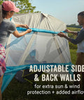 Two people setting up Portable 7x7ft Backpack Sun Shelter with Lightweight Shade Canopy, adjustable side and back walls, outdoors.