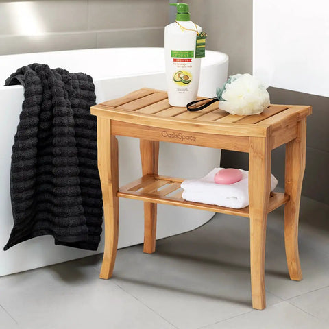 Bamboo Shower Bench 19 Inch Waterproof Shower Chair With Storage Shelf next to bathtub holding towel and toiletries