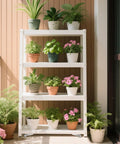 White plant shelf with assorted potted plants on a patio balcony