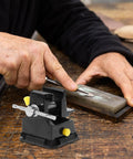 Person using a Go To Mini Table Vise Clamp With Suction Base For Jewelry Making And Model Repair on a workbench.