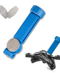 Bicycle Hydraulic Brake Caliper Spreader Tool for Mountain and Road Bikes with magnetic pads, shown with caliper and disc pads