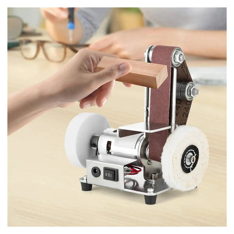 Compact Mini Electric Belt Sander, versatile desktop grinding machine for wood and metal polishing in use with wood piece.