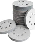 Premium 5 Inch Sanding Discs With 8 Holes For Dust Free Grinding, stacked and laid out for wet or dry use.
