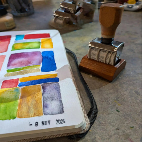 Gotta Have This Slick Roller Date Stamp Drops Crisp Day Month Year Marks On Planners Scrapbooks Cards And Diy Crafts Made From Hella Durable Solid Natural Wood For Daily Planning on a colorful watercolor page.
