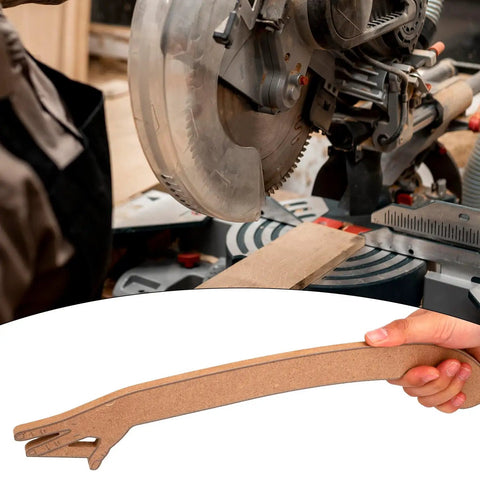 Hand Shaped Table Saw Push Stick Safety Block With Missing Finger Design for woodworking, held near a miter saw.