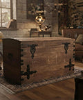 Vintage Antique Cast Iron T Hinges For Cabinet Doors 5 Point 3 Inch on a wooden storage chest in a rustic room.