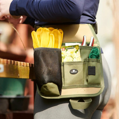 Person wearing All In One Garden Tool Pouch Belt With Grab And Go Multi Pocket Utility Apron featuring pouches, tools, and gloves.