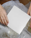 Person using 100 Pcs White EPE Foam Pouches Packing Supplies with Shock Resistance for glassware protection.