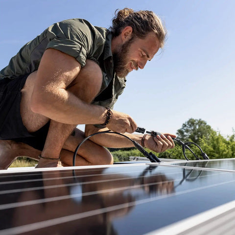 Person using Solar Y Branch Connectors For Panels 1 To 3 Parallel Cable Kit M/FFF And F/MMM on solar panels outdoors.