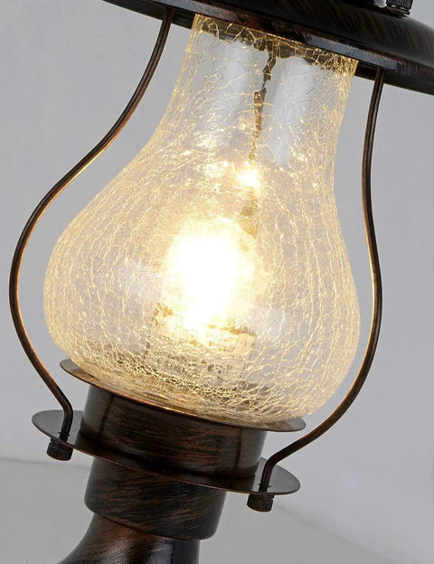 Close-up of No Fuss Dusk To Dawn Outdoor Post Lights with Photocell Sensor, featuring rustic oil rubbed brown lantern with crackle glass.