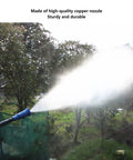 Heavy Duty High Pressure Garden Sprayer With Adjustable Nozzle spraying mist over lawn, showcasing long range atomizer in use.