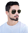 Man wearing unisex hexagonal flat lens sunglasses with lightweight gold metal frame and G fifteen green lenses 54 mm medium fit