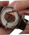 Close-up of a watch repair using All In One 1100Pcs Stainless Steel Eyeglass Screw Kit With Nuts And Hinges Repair Tools kit.