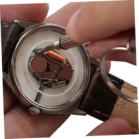 Close-up of a watch repair using All In One 1100Pcs Stainless Steel Eyeglass Screw Kit With Nuts And Hinges Repair Tools kit.
