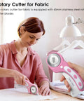 Woman using 45mm Rotary Cutter Set With 5 Extra Blades For Fabric Leather Crafting Sewing And Quilting Ergonomic Grip