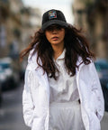 Stay Cool With This Breathable Yacht Style Hat For Men And Women Unisex Cap All Season Lightweight Moisture Wicking Adjustable Fit Perfect For Running Hiking Cycling And Everyday Outdoor Wear Go To Pick For Everyday Adventures worn by a woman in white jacket