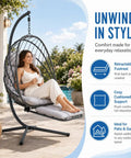 Woman relaxing in Chill Hanging Egg Chair With Stand And Retractable Footrest In Dark Gray Frame Wicker Rattan Swing Chair by pool.
