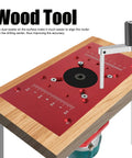 Top Shelf Aluminum Alloy Router Table Insert Plate With Wicked Smooth Lift System And Two Swap Ready Rings For Garage Woodworking Benches Shop Badass Heavy Duty Router Base Board Accessory Sharp Red Finish on wooden bench.