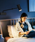 Battery Operated Picture Light With Telescoping Arm, Adjustable 7.8 To 13.8 Inches, Silver Finish, illuminating bedroom over bed.