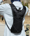Person wearing Go To Nylon Hydration Backpack With Reflective Strips Lightweight Adjustable Reservoir outdoors