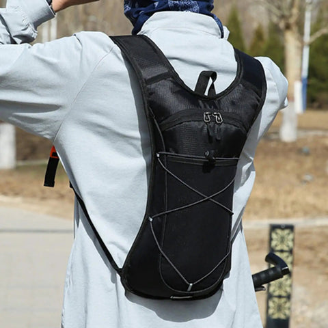 Person wearing Go To Nylon Hydration Backpack With Reflective Strips Lightweight Adjustable Reservoir outdoors