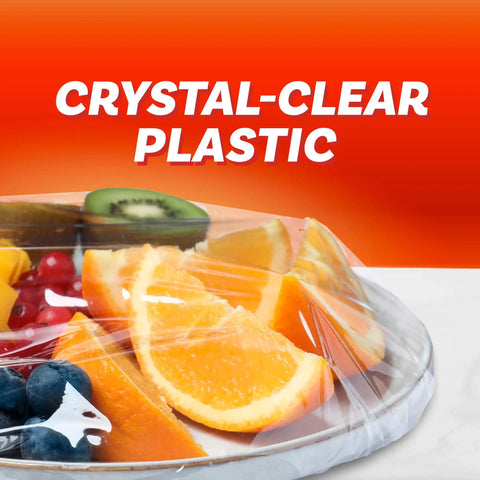 Ridiculously Handy Clear Plastic Wrap for Kitchen Storage covering fruit on a plate, extra long roll with easy dispense.