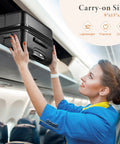 Flight attendant storing lightweight spinner carry on luggage in overhead bin.