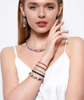 Woman wearing jewelry made with Six Millimeter Flat Round Spacer Beads Pack Of 1500 Silver Rondelle Beads for necklaces and bracelets.