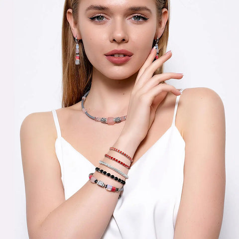 Woman wearing jewelry made with Six Millimeter Flat Round Spacer Beads Pack Of 1500 Silver Rondelle Beads for necklaces and bracelets.
