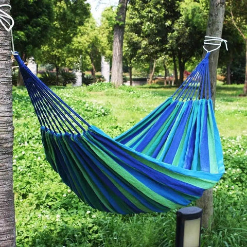 Durable Portable Cotton Hammock For Camping And Outdoor Indoor Use With Hanging Ropes Carrying Bag Blue Large in a garden